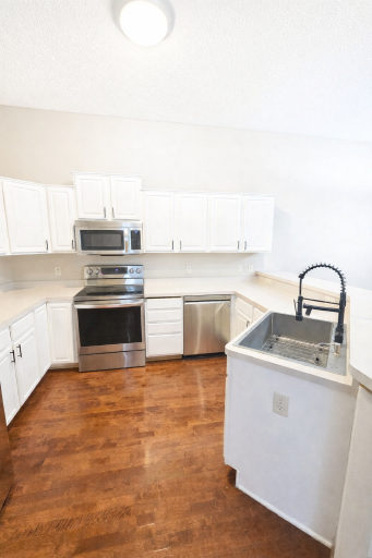Kitchen offers white enameled cabinetry, Stainless steel appliances