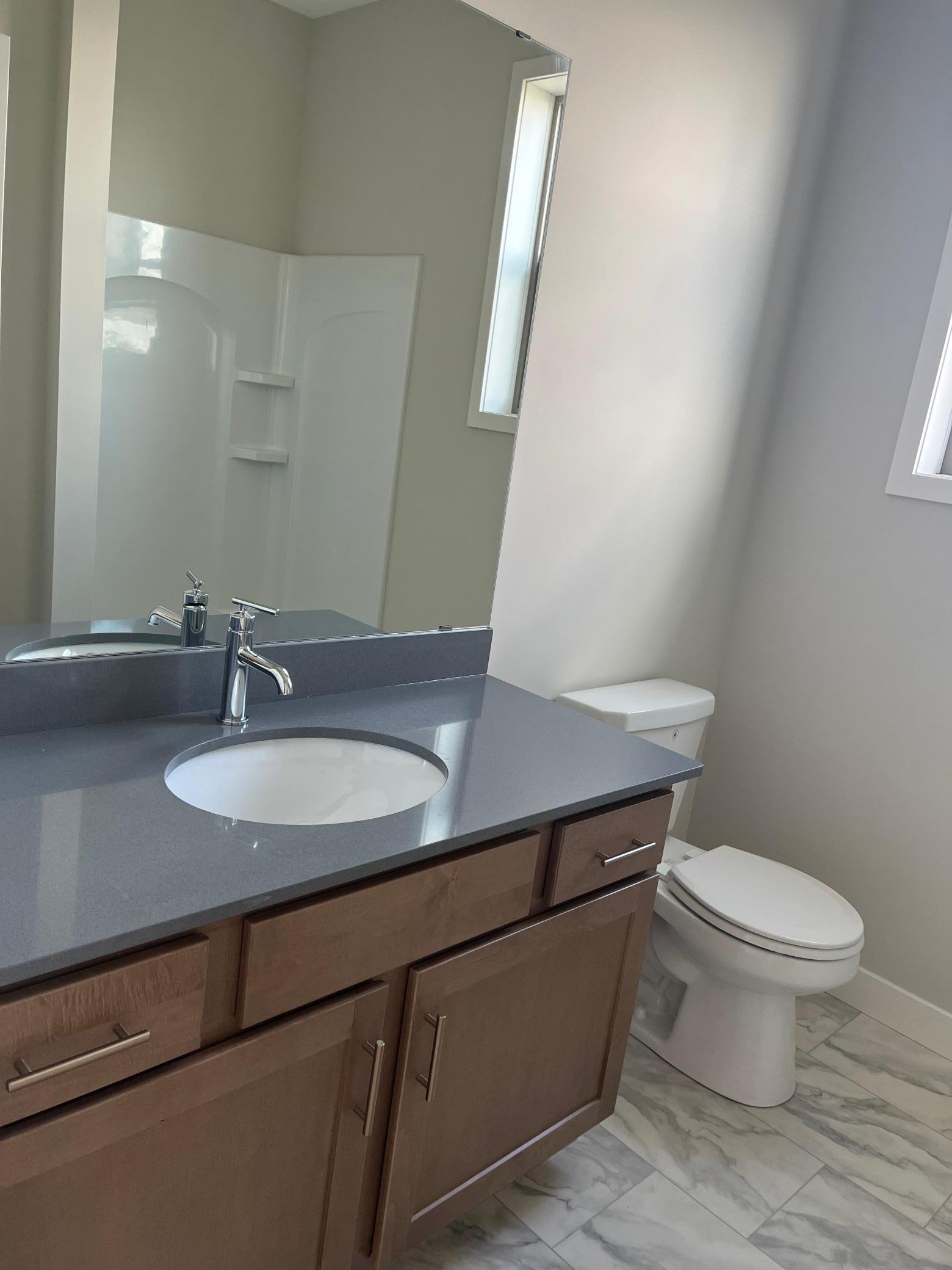 Main level bathroom with shower for guests, dog wash station, or to wash of kids' feet