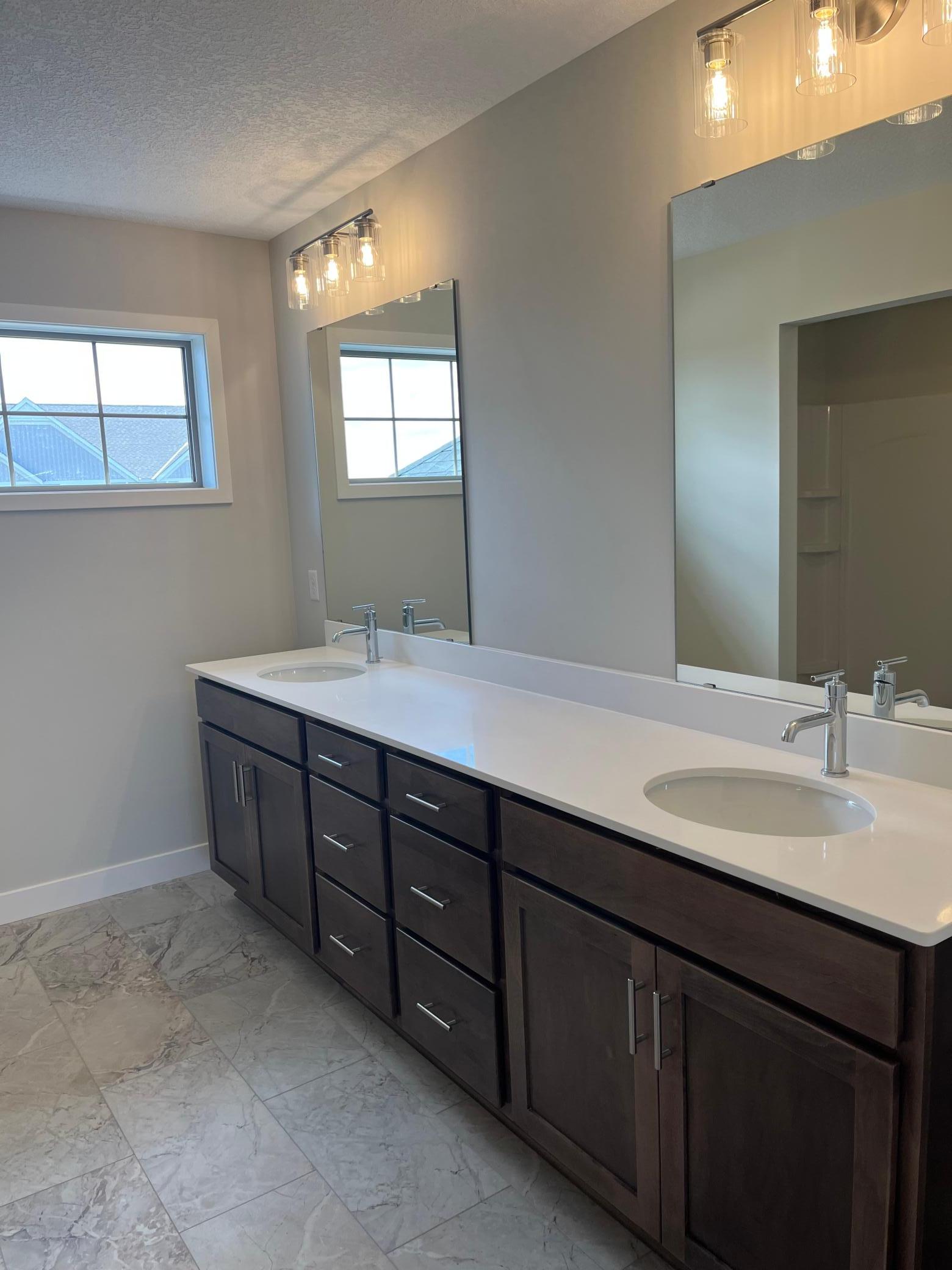 Fantastic owner's bathroom with large double vanity. Shower and toilet are in an alcove. Linen closet.