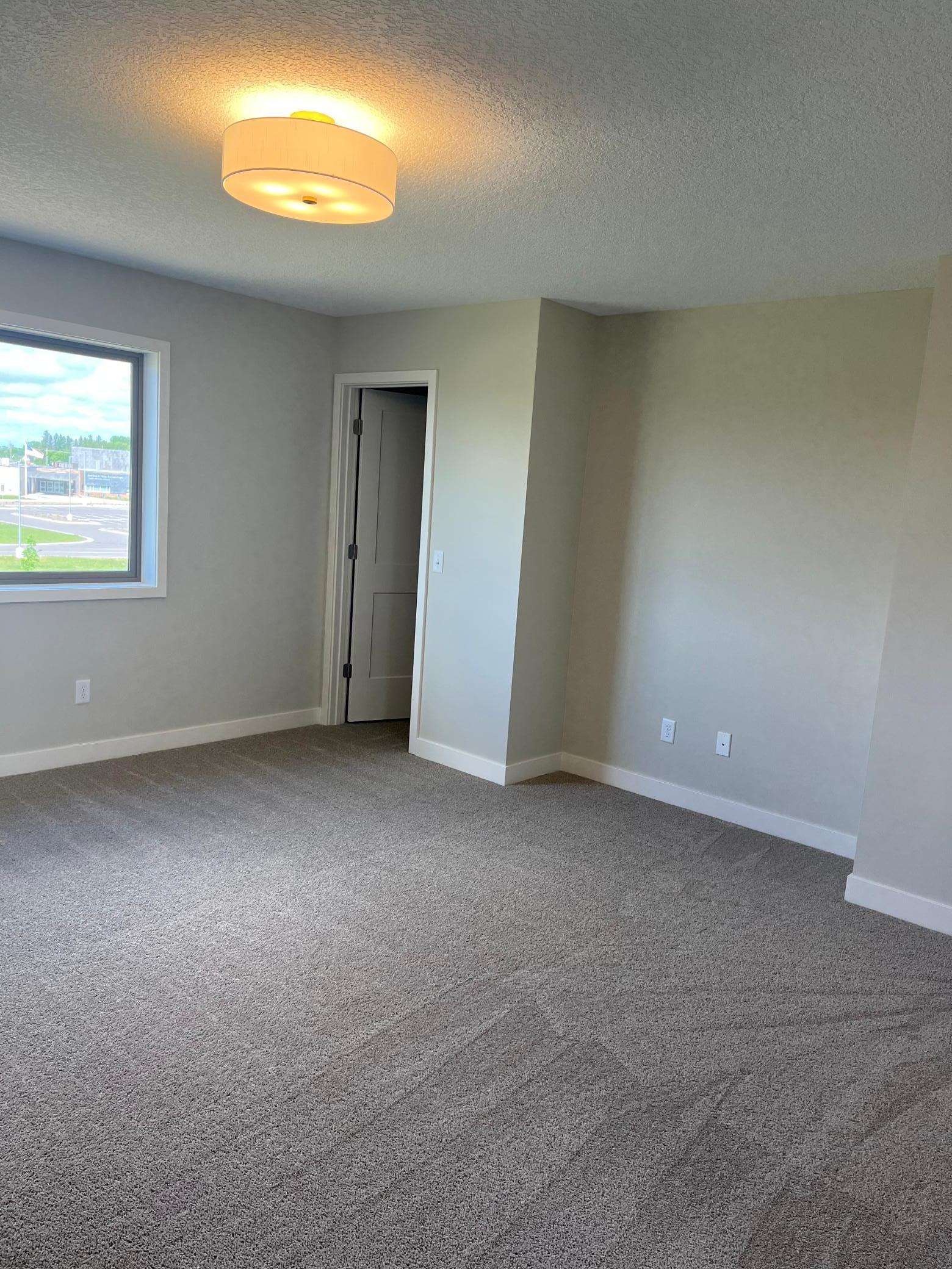 Owner's bedroom with notched area for dresser, desk, or TV.