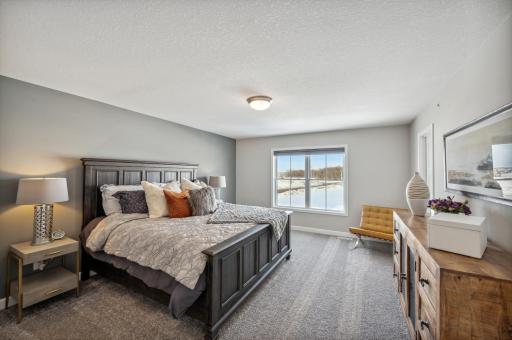 Serene primary suite offering generous space and tranquil natural light *Photo of actual home