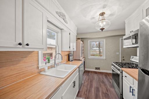 Some new cabinetry and some cabinetry with updated doors. Gorgeous, neutral kitchen is ready for you.