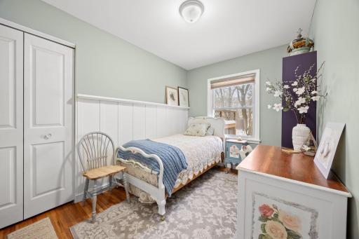 Another one of the three main level bedrooms, with beautiful details, including wainscoting and a picture ledge.