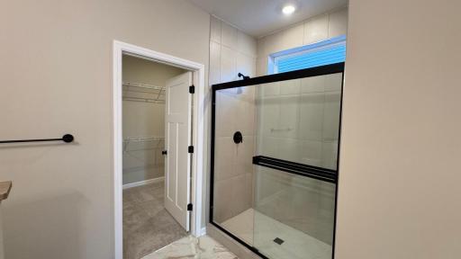 Ceramic tile shower and floor, plus transom window Image is of Actual Home