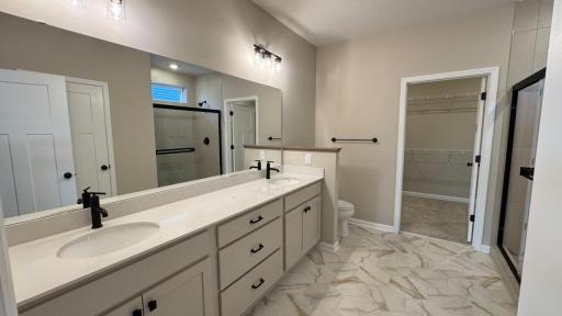 Owner's Bath, notice the center drawers, plenty of space!! Image is of Actual home