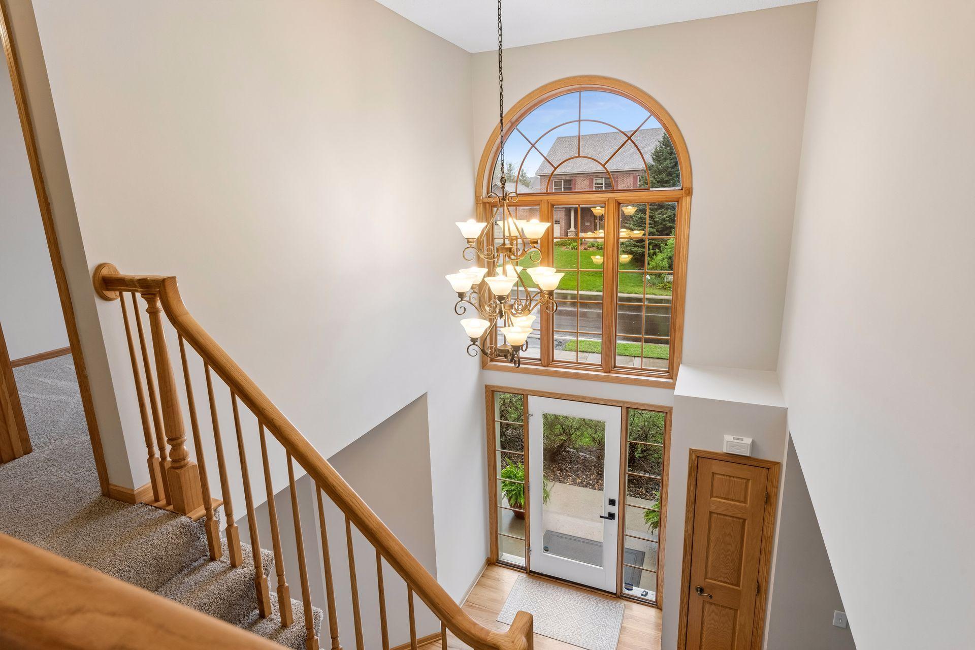 Stunning two story entry highlighted by a statement chandelier and oversized window.