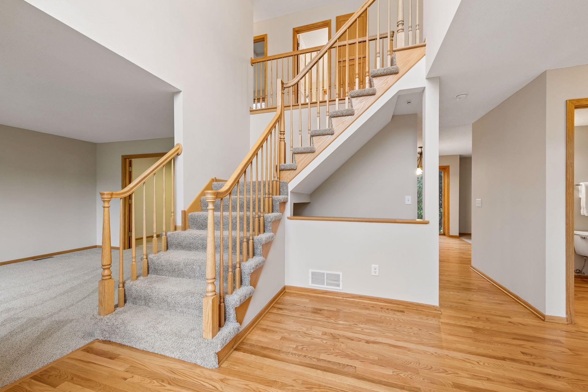Open and airy entry with a sweeping staircase and brand new carpet.