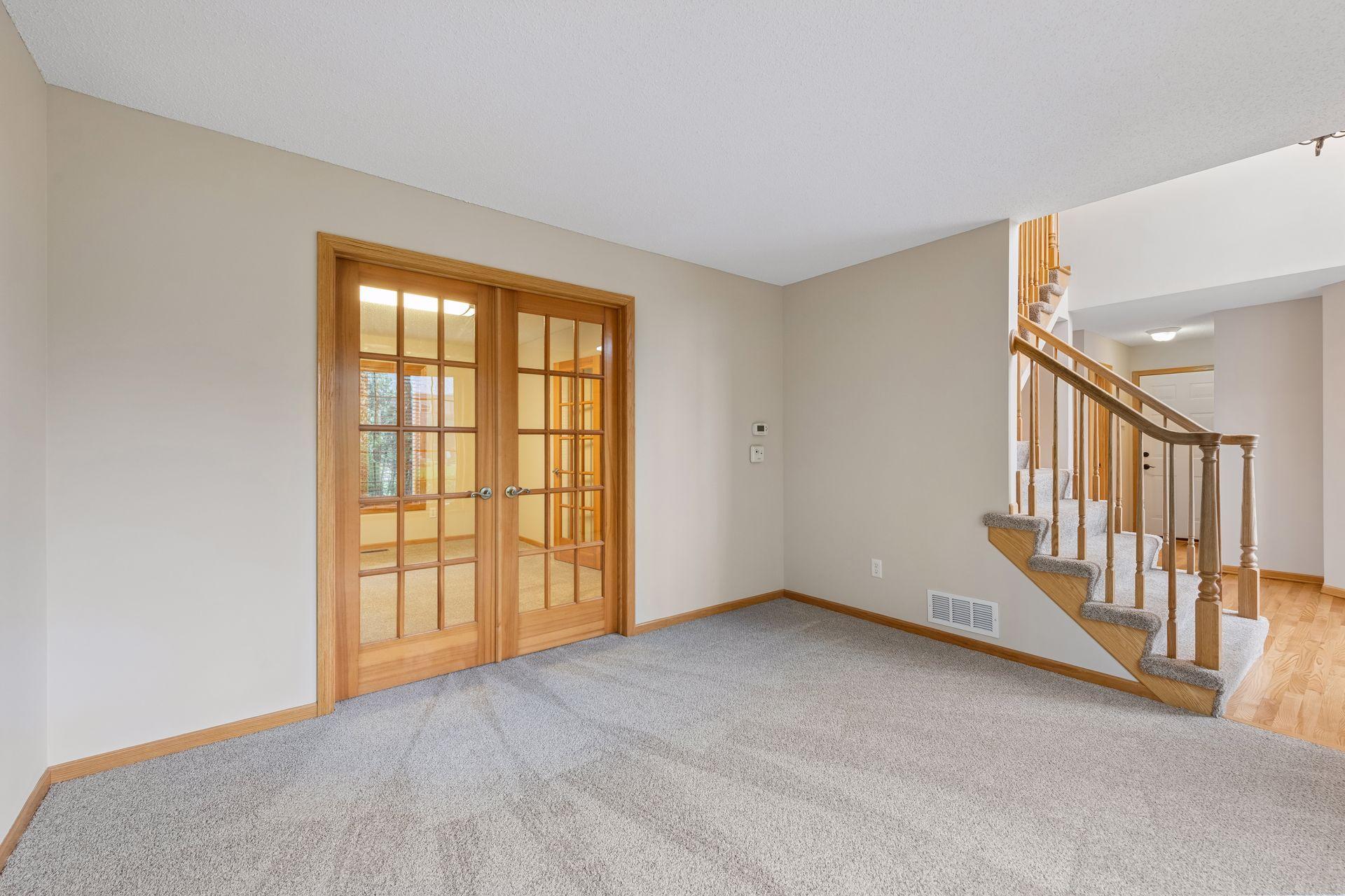 French doors lead to a versatile main level room - ideal for a separate dining area, home office, sitting room or playroom for the kiddos!