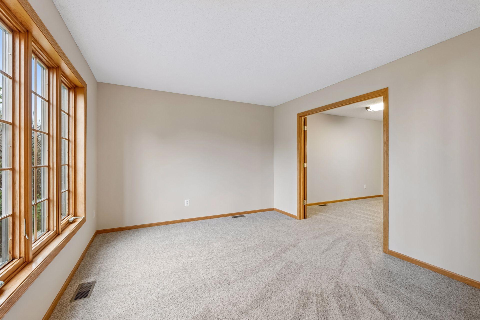 Spacious living room with plush new carpet and flexible layout options.