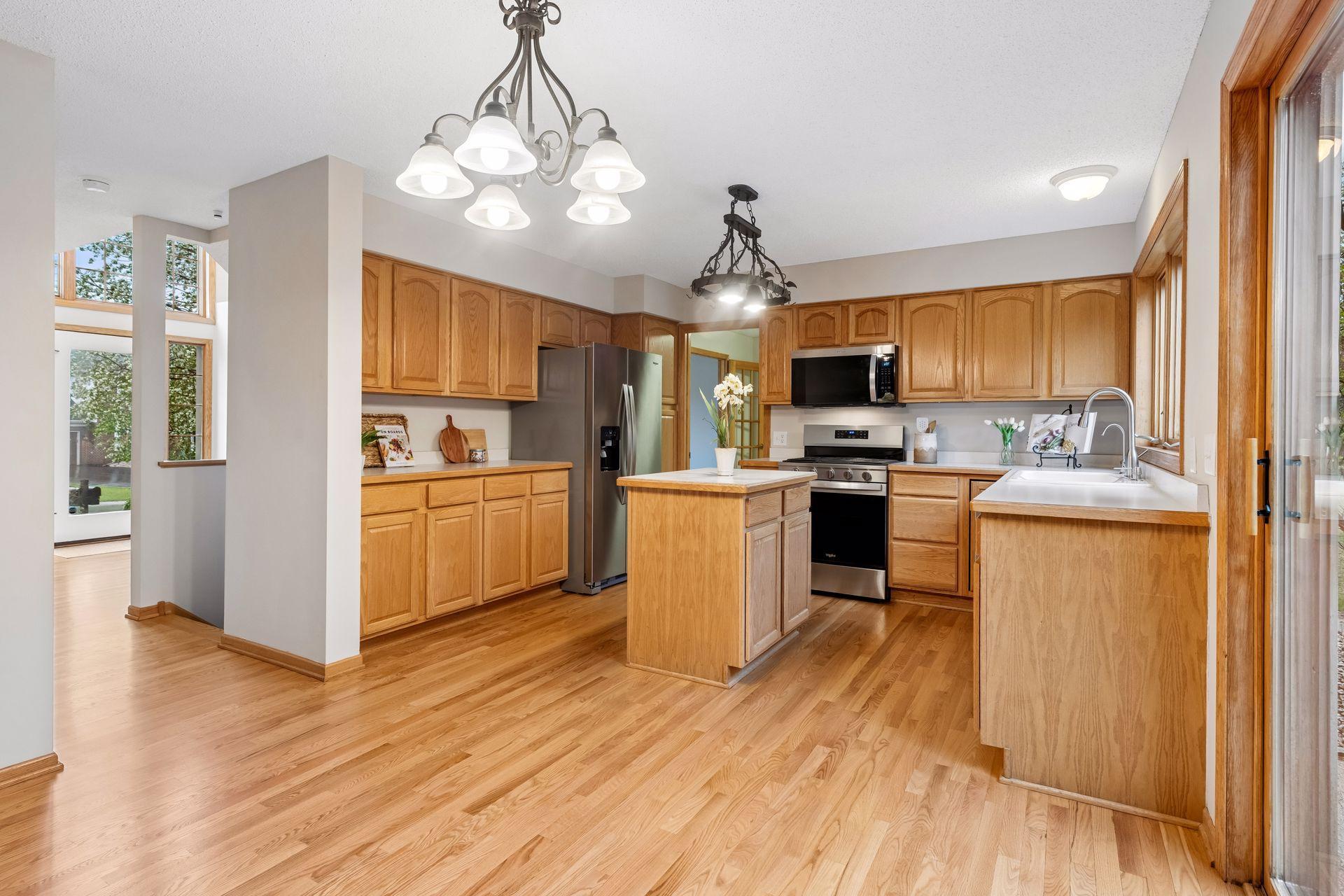 Bright and functional kitchen with brand new stainless steel appliances and ample prep space
