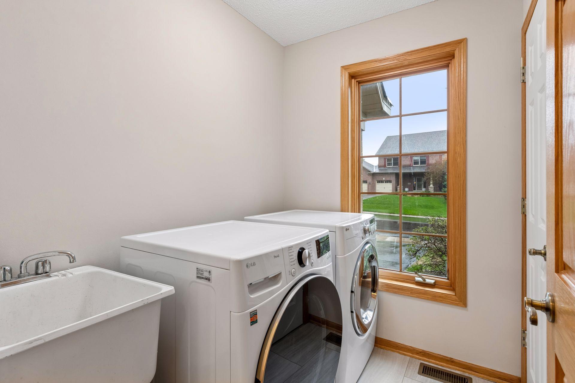 Main level laundry room is the perfect catch all room right off of the garage.