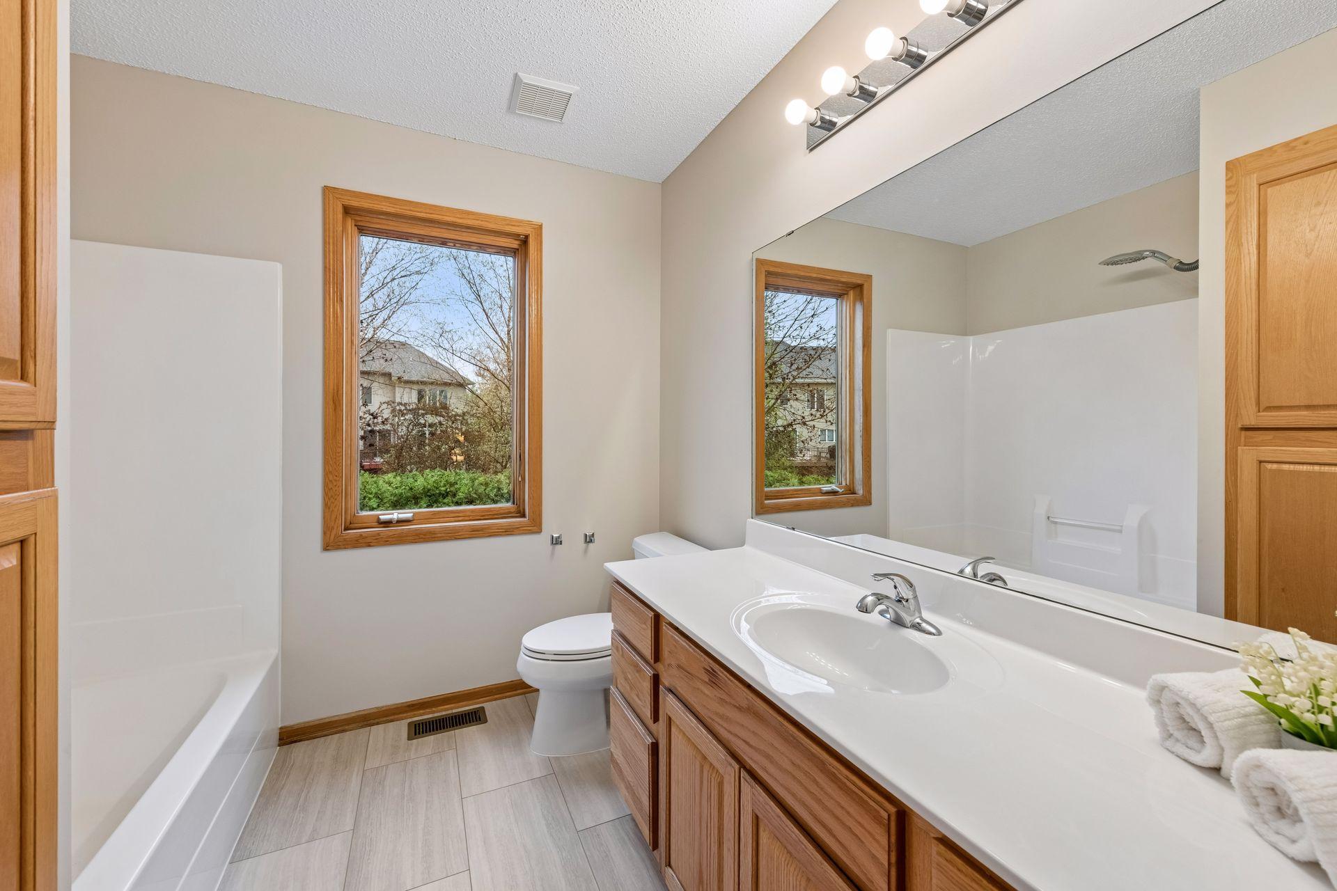 Upper level full bathroom with brand new flooring, new paint and updated lighting
