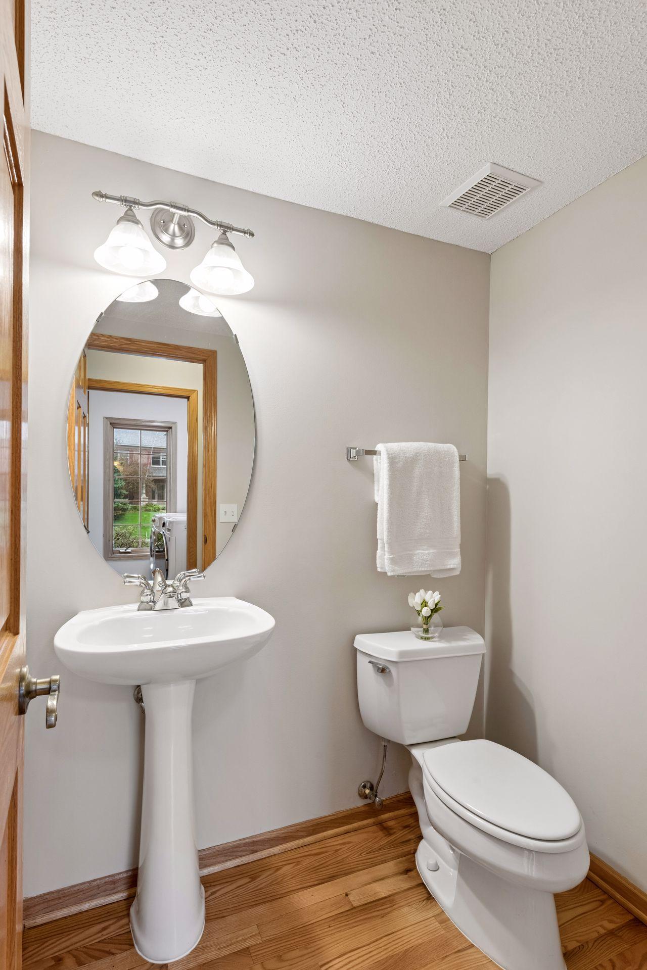 Stylish main level powder room with pedastal sink