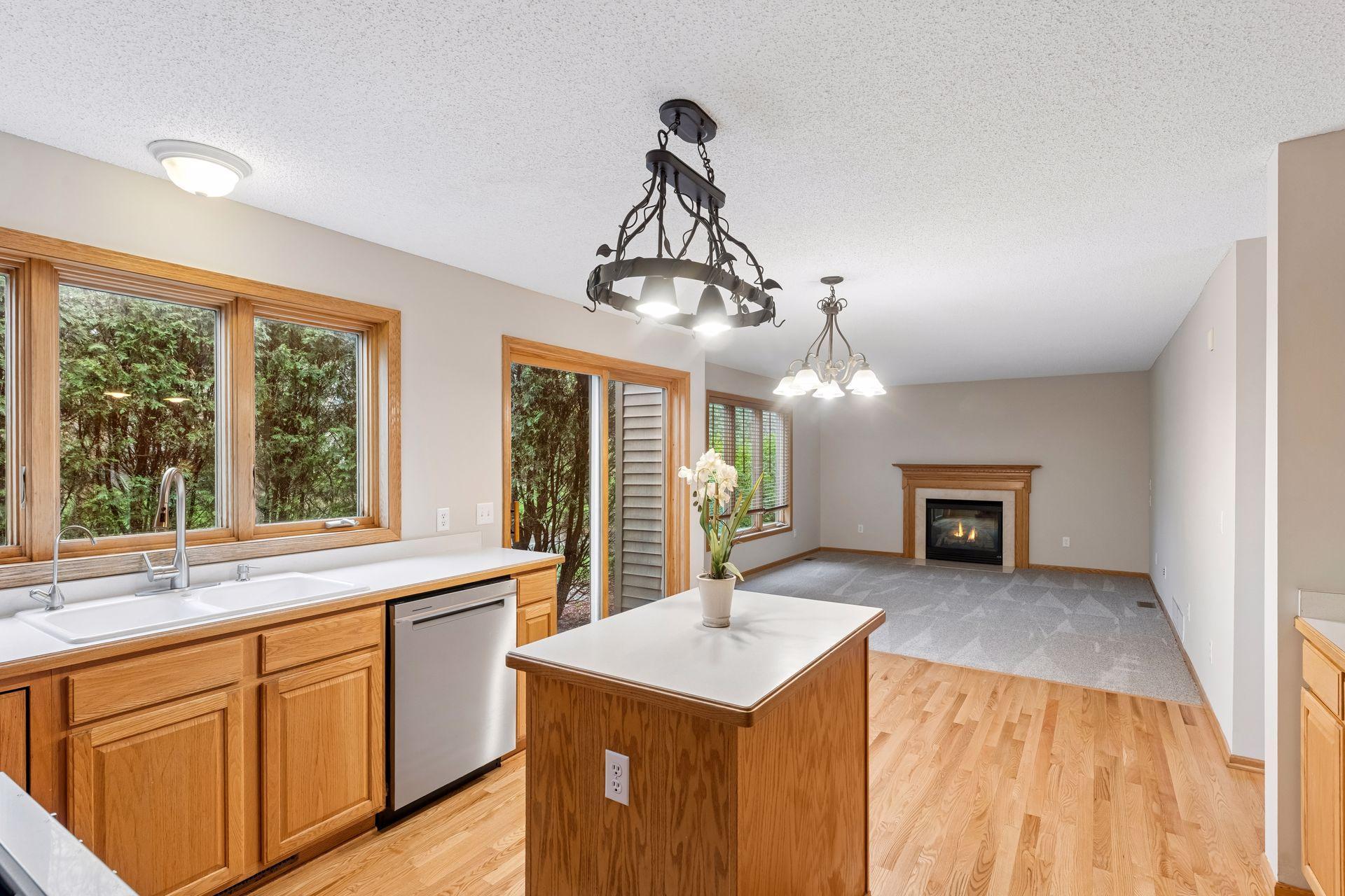 Seamless flow from the kitchen to the family room with a a cozy fireplace