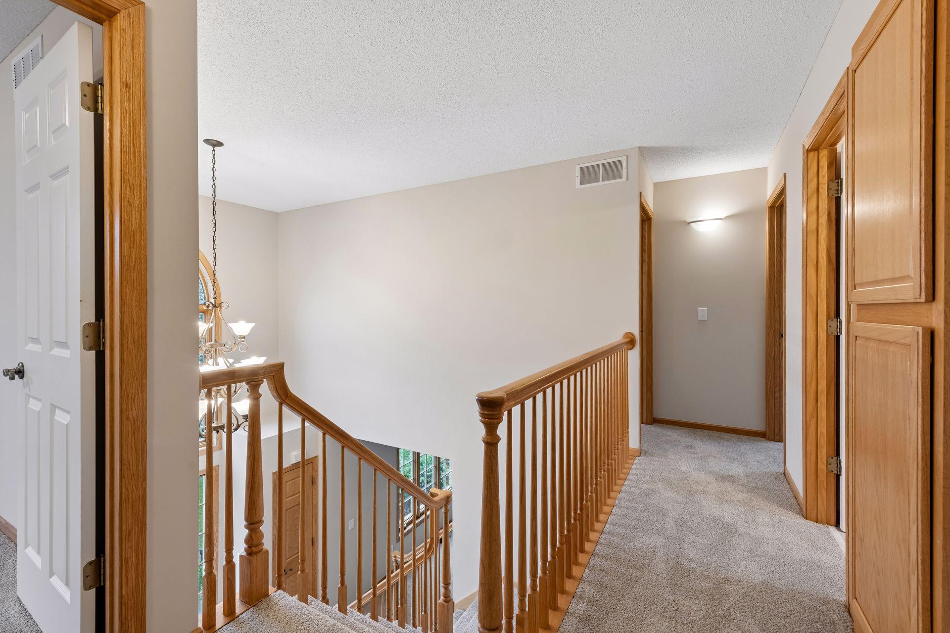 Spacious upper level hallway connecting the four bedrooms
