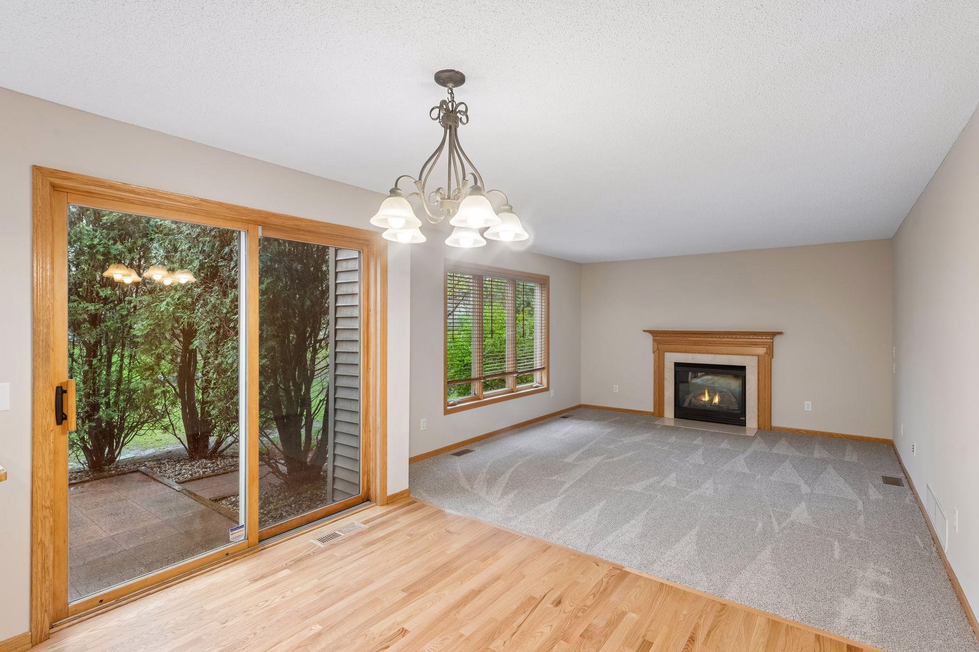 Spacious living area with seamless flow to dining space and patio access.