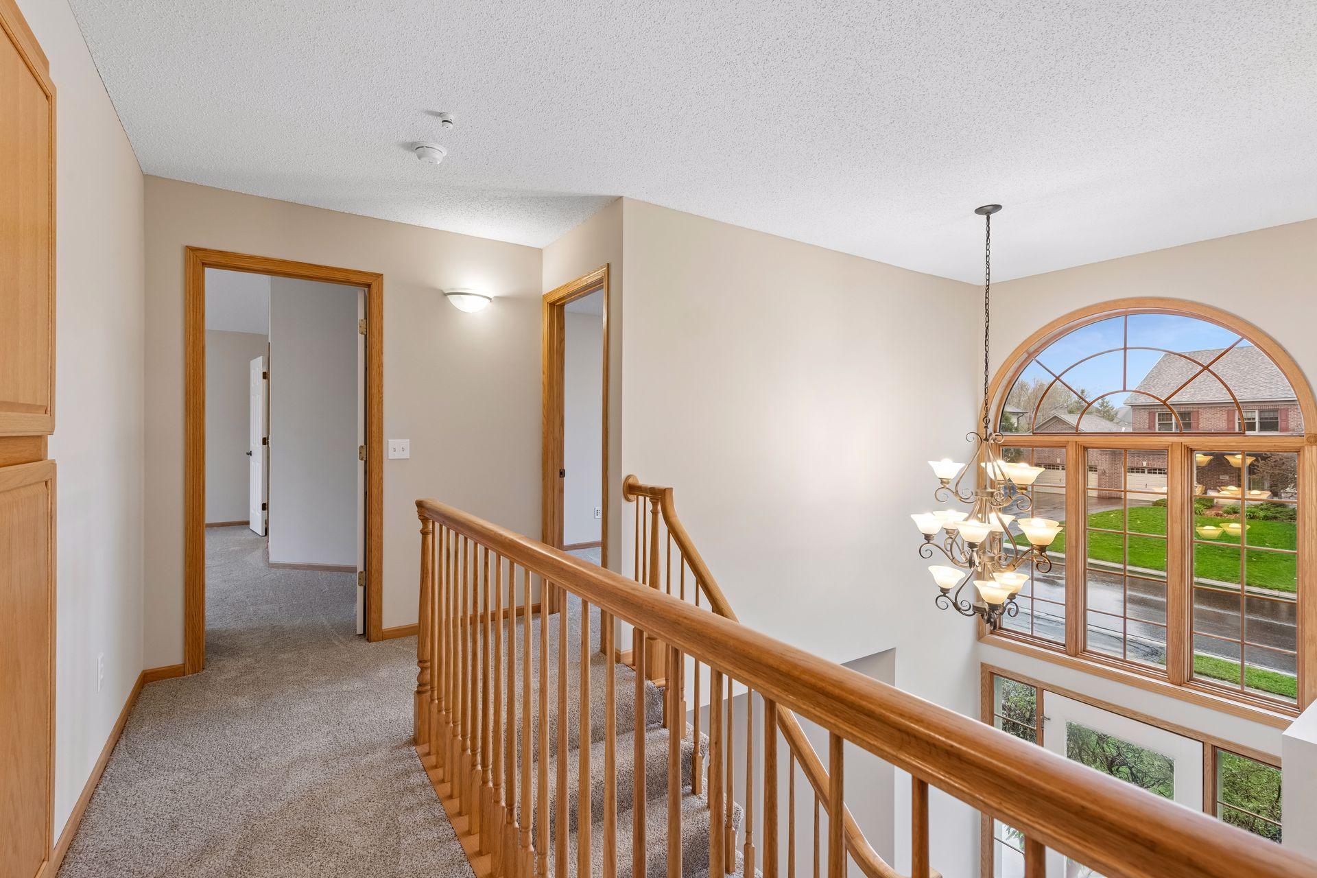 Upper-level landing with open railing looking over foyer