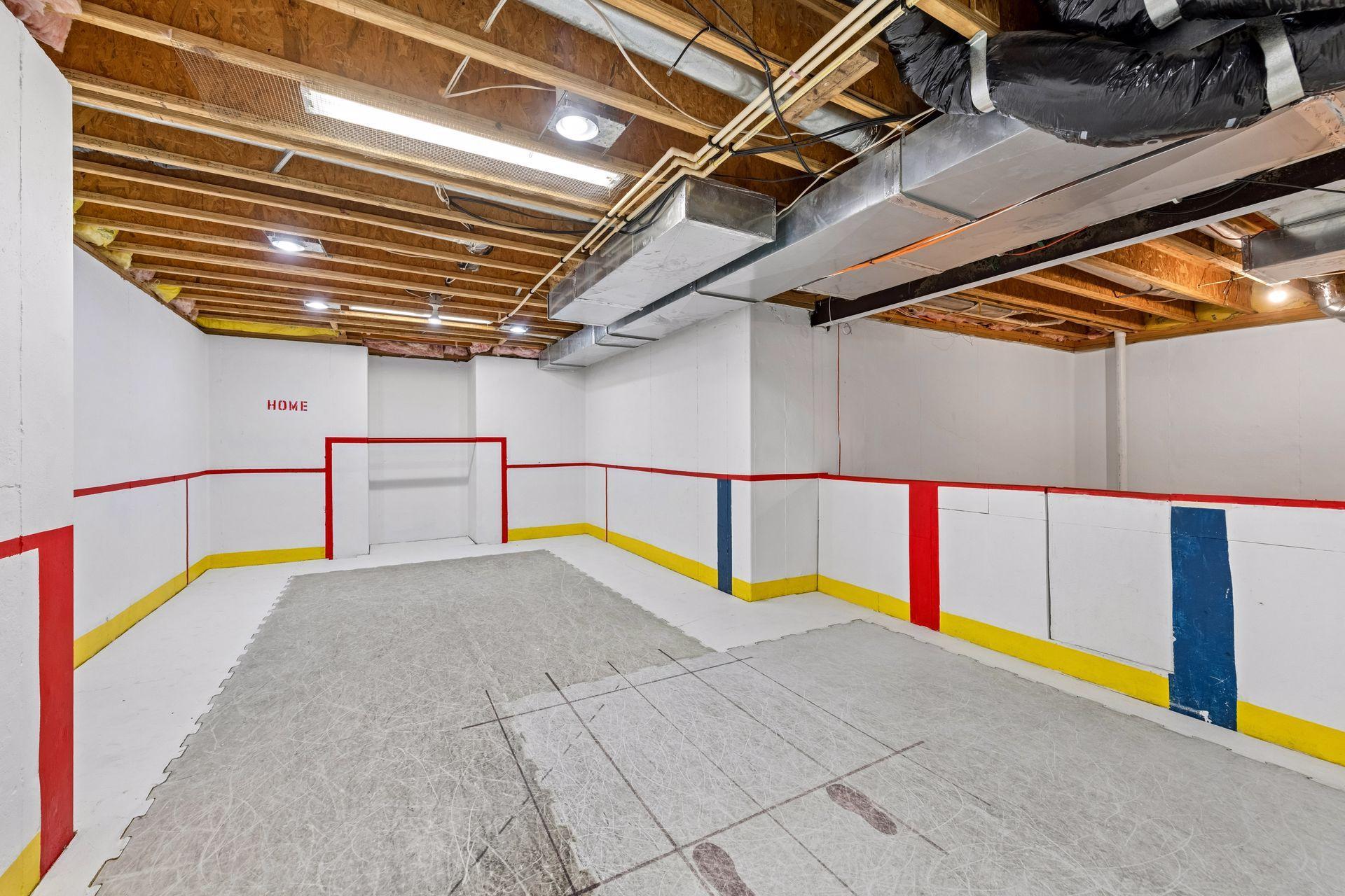 The basement of every hockey player's dreams! Synthetic ice and boards to practice at home