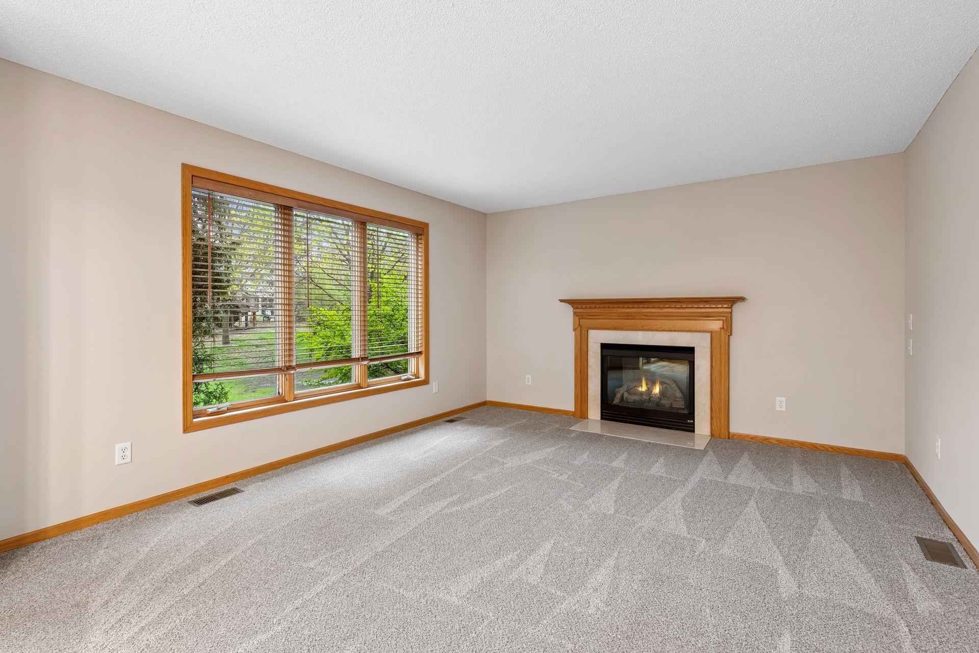 Sun-filled family room featuring plush new carpet, new paint and amazing backyard views