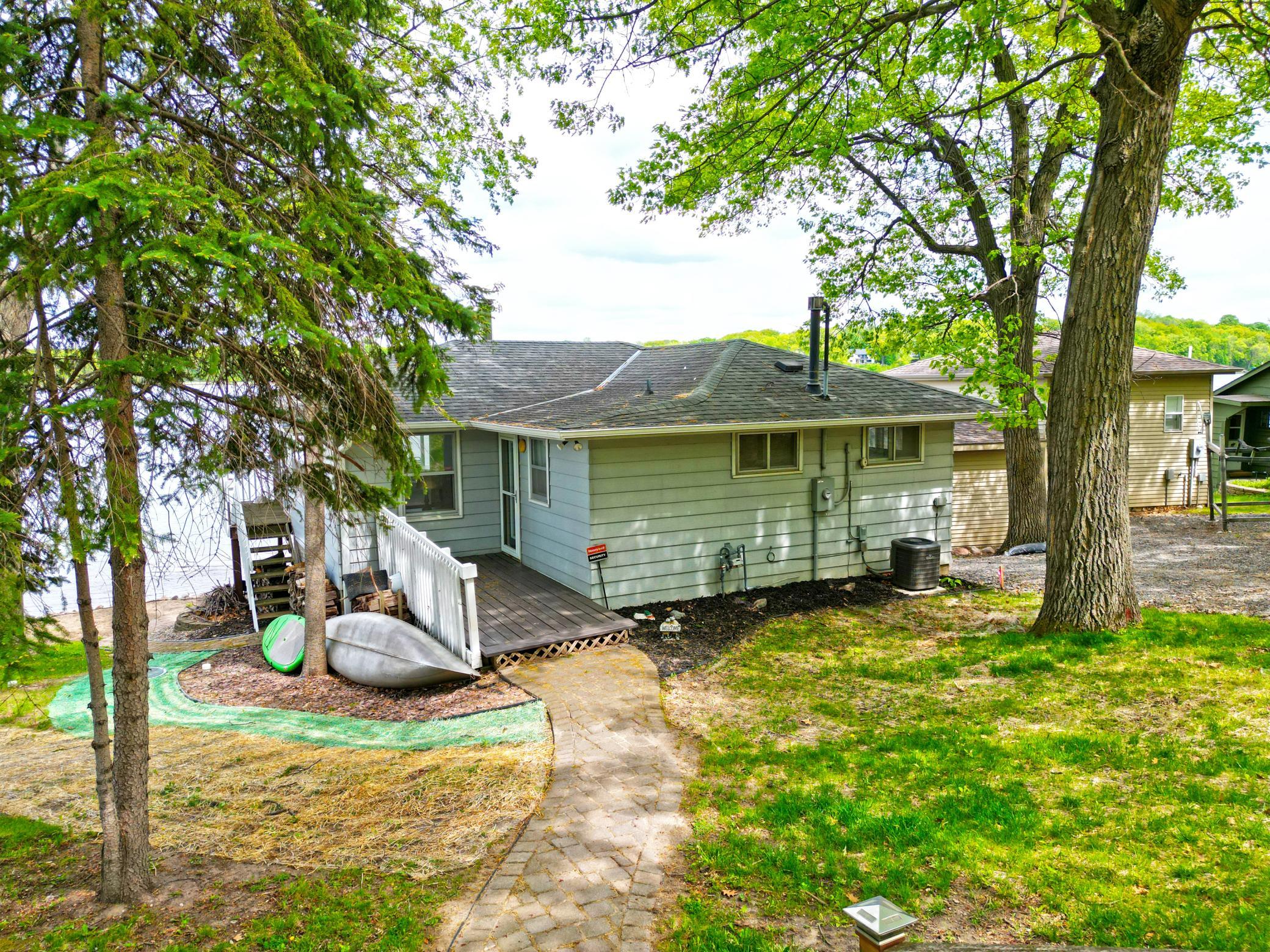 A stone walkway leads you to your entry deck shaded by stunning towering trees.