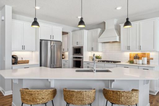 Quartz countertops, stunning backsplash, and more cabinet and counter space than you can imagine! Welcome to the family chef's dream! Model home, color and finish will vary.