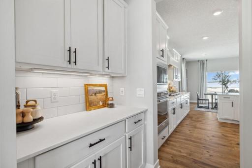 Butler's pantry provides extra space for both storage and display! Model home, color and finish will vary.