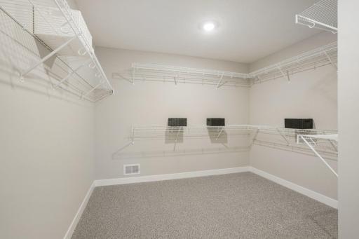Just look at this MASSIVE walk-in closet in the primary suite! Influencers will be envious! Photo of model home, colors and finishes will vary.