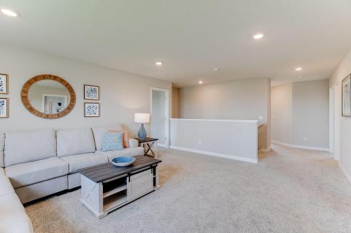 With room for large furniture or a sectional, there's space for everyone to relax. Photo of model home, colors and finishes are similar.