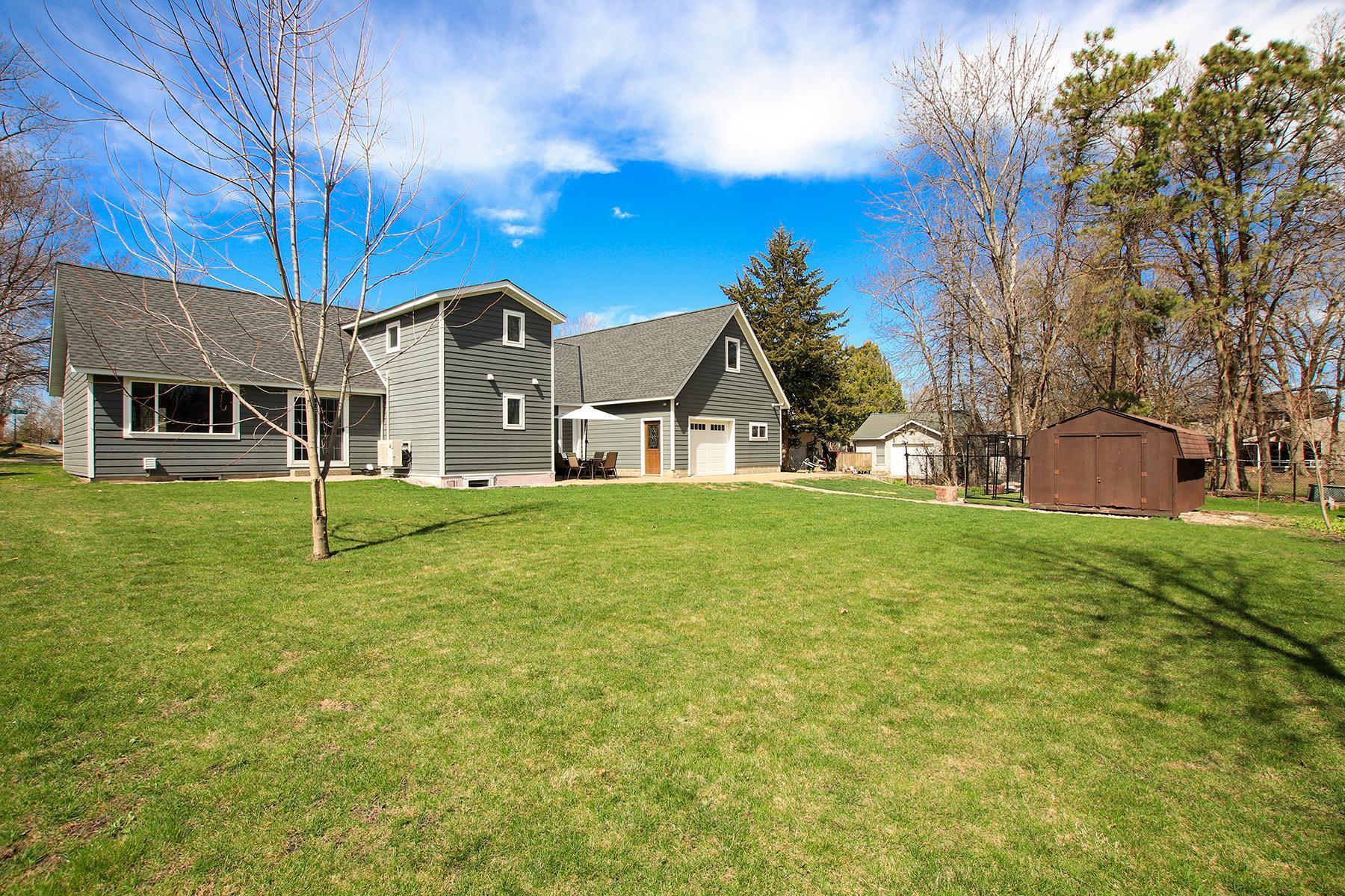 Backyard with dog kennel and shed.