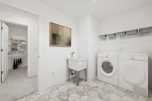 (Photo of a decorated model, actual homes finishes and colors will vary) Upper-level laundry.