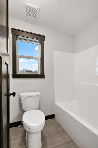 Upper level full bathroom with separate room for stool and tub/shower