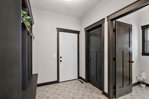 Mud room off the garage with walk in closet, 1/2 bath and custom lockers