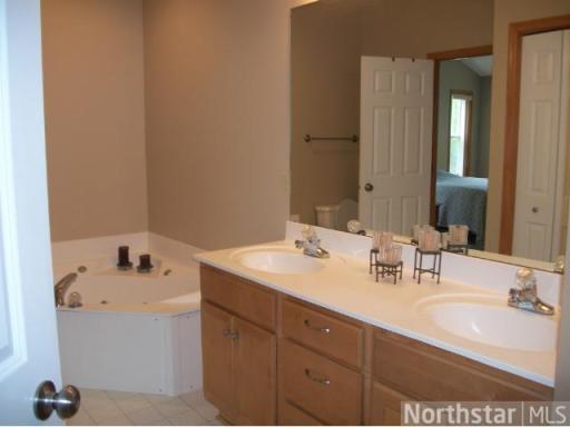 Upper level bathroom has double sinks and walk through from Master bedroom