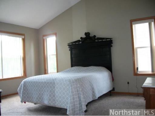 Large master bedroom with vaulted ceilings.