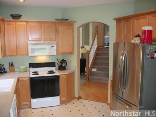 Kitchen is situated next to informal dining area and living room.