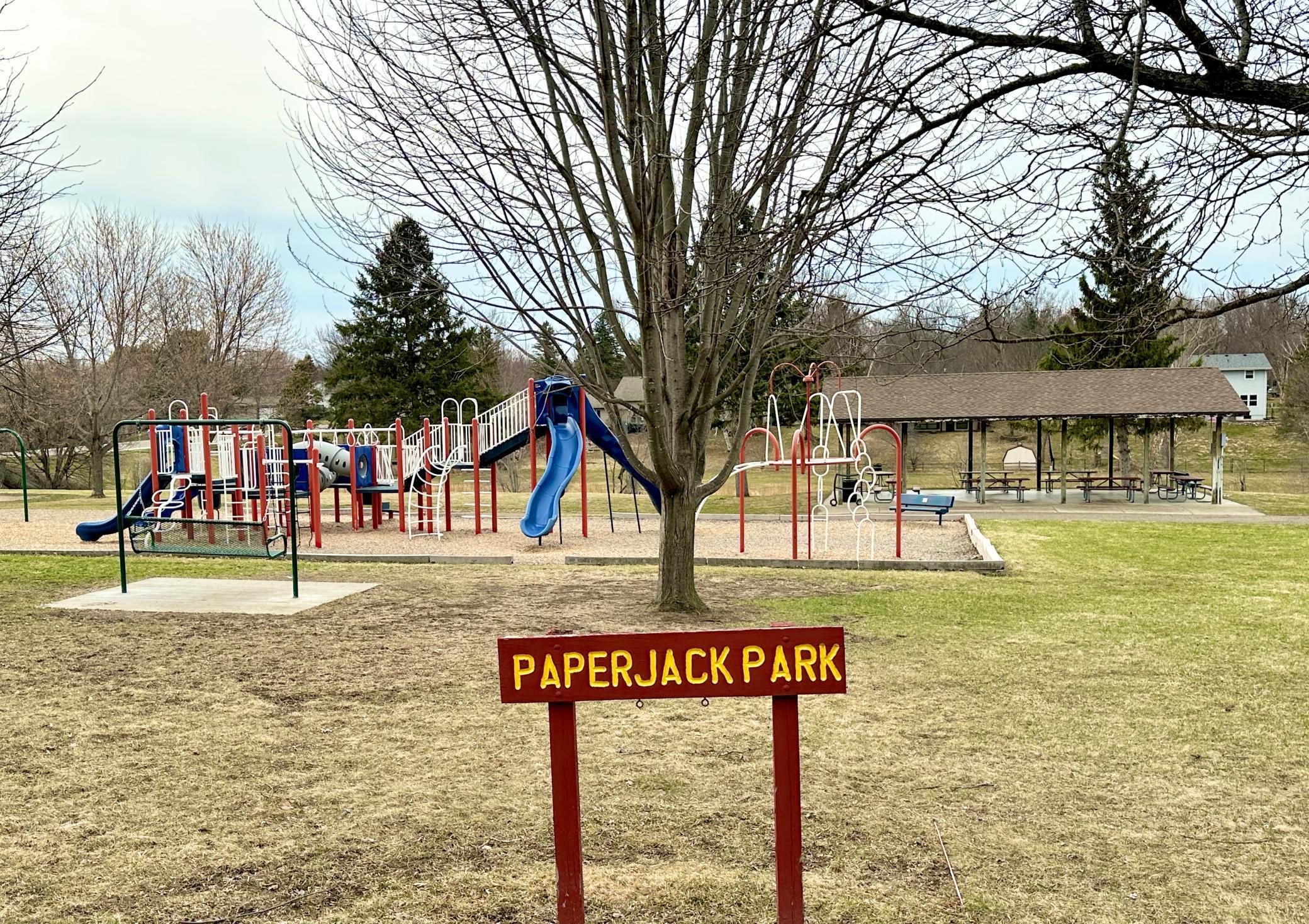 Paper Jack Park has play ground equipment for kids, a covered picnic space for family gatherings, bathrooms, paved parking with a basketball net and lots of green space.