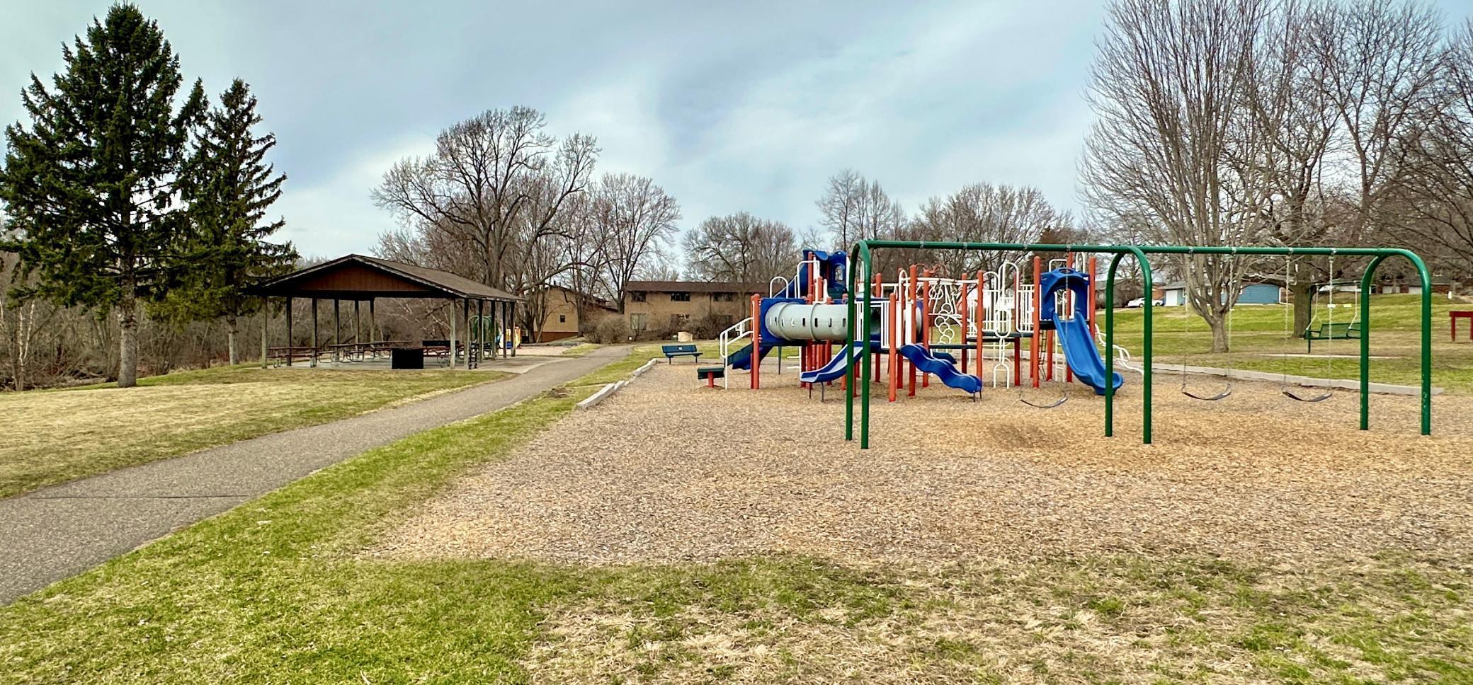 Paved walking/biking path leads to and through the through the park.