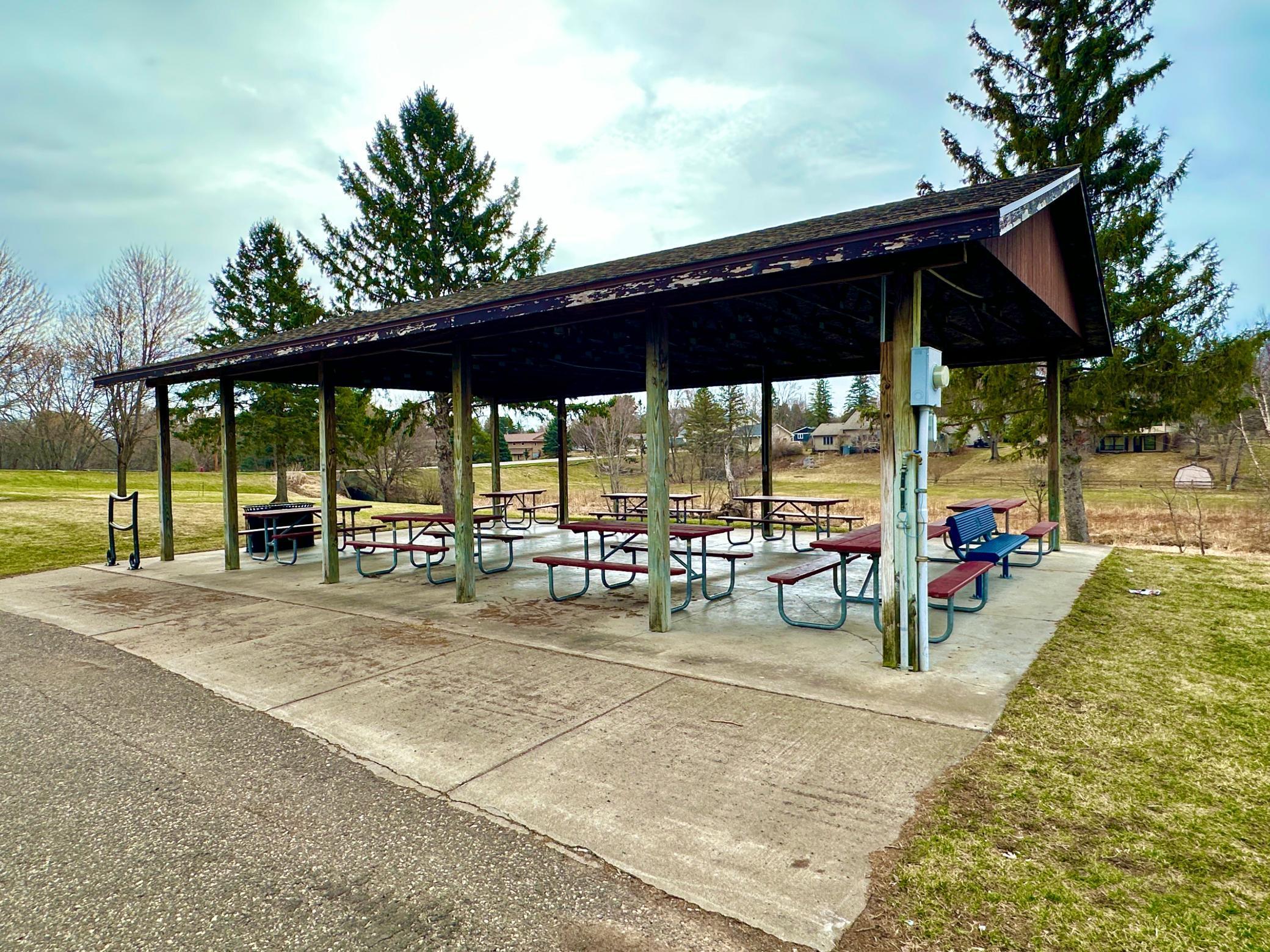 Covered picnic area with lots of picnic table seating.