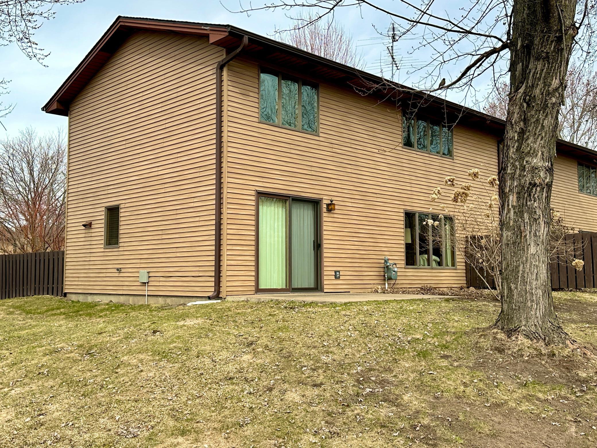 The unit has a patio out back with some privacy to the park from a lilac hedge.