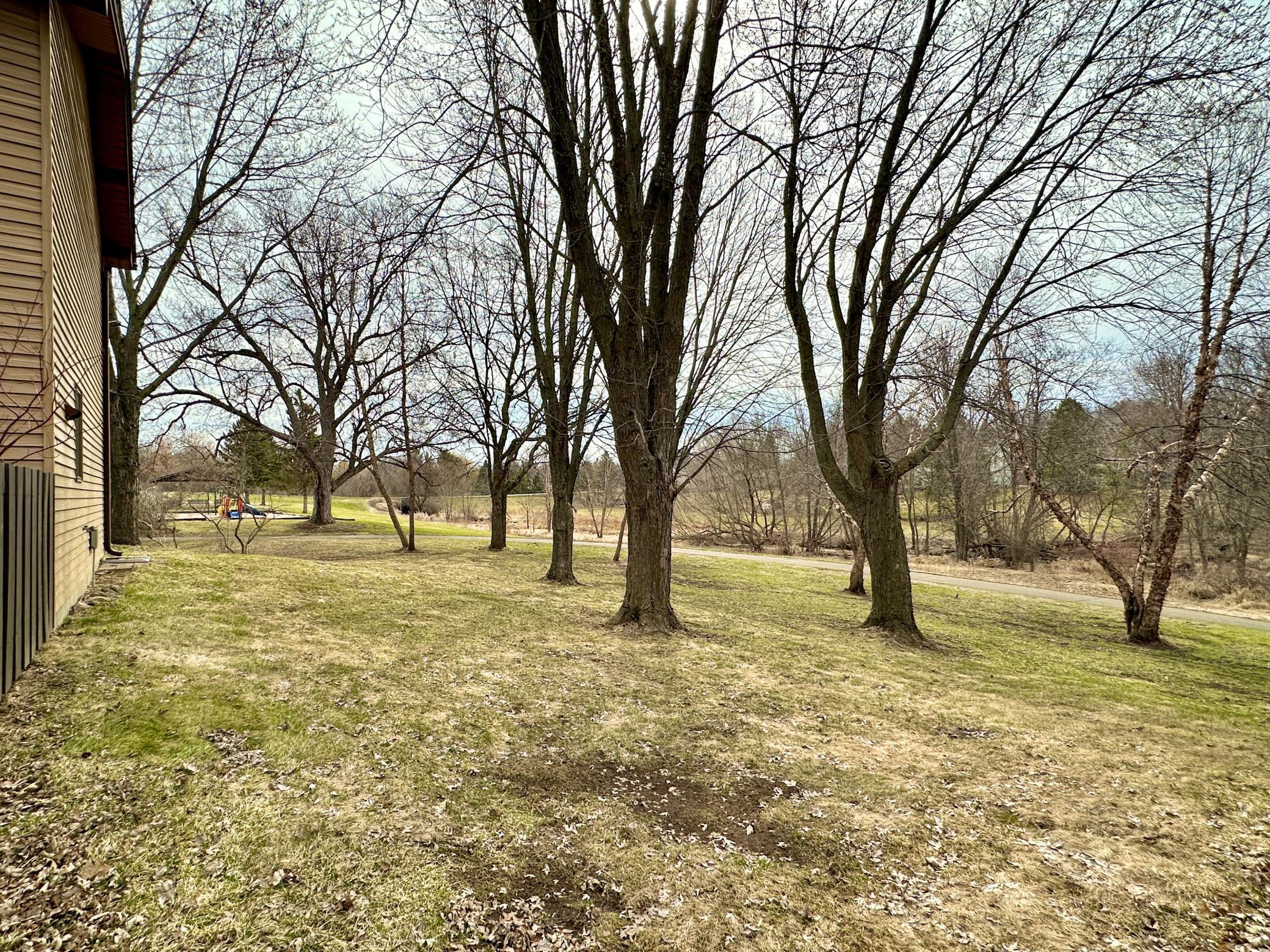 This view from the front of the unit showing the walking path running along the creek.