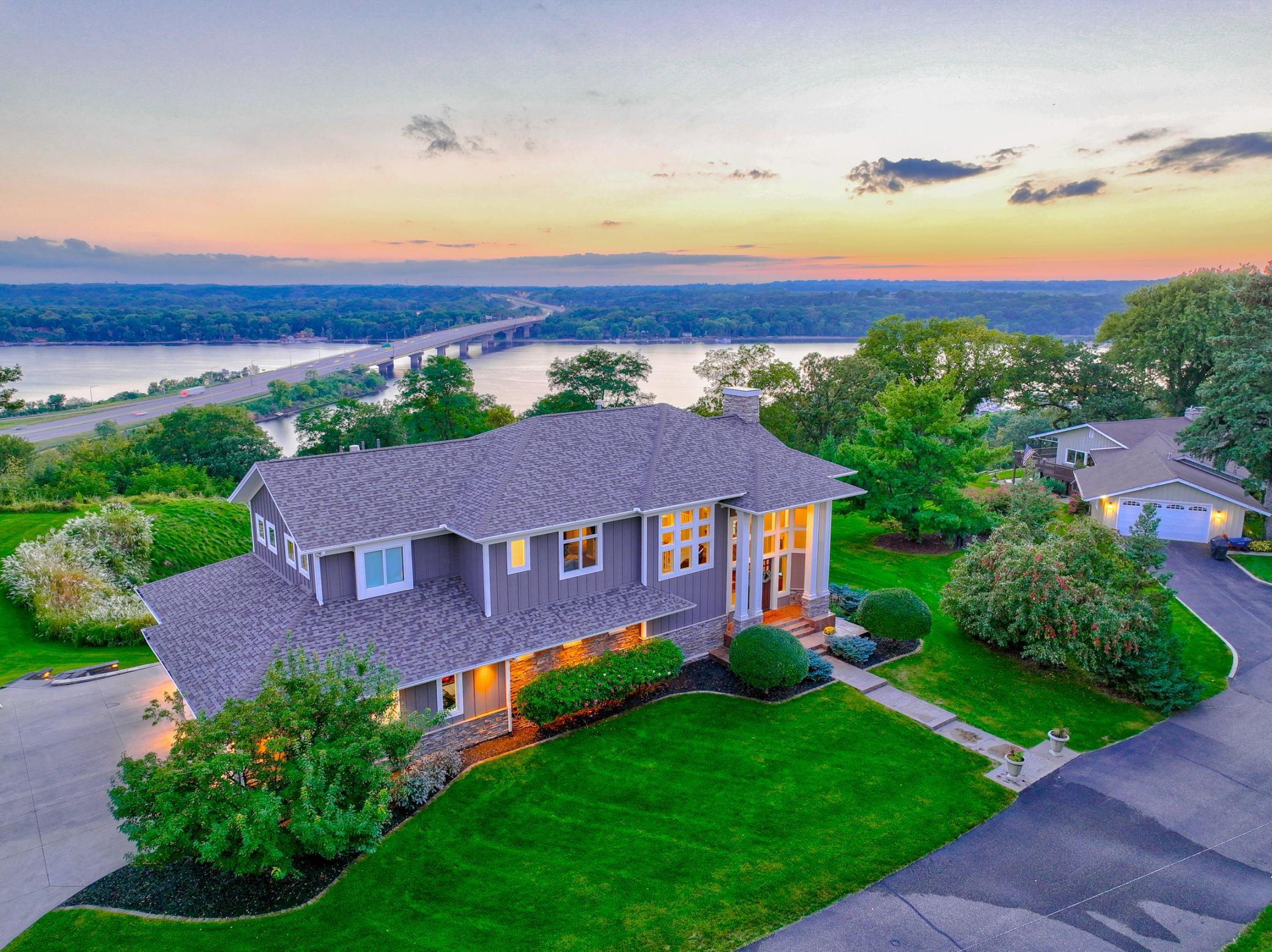 The oversized four-car garage features a Spancrete design with heated epoxy floors, and a mirrored tuck-under storage below, offering exceptional space for vehicles, recreational equipment, and more. Convenience of in-town living with scenic views.