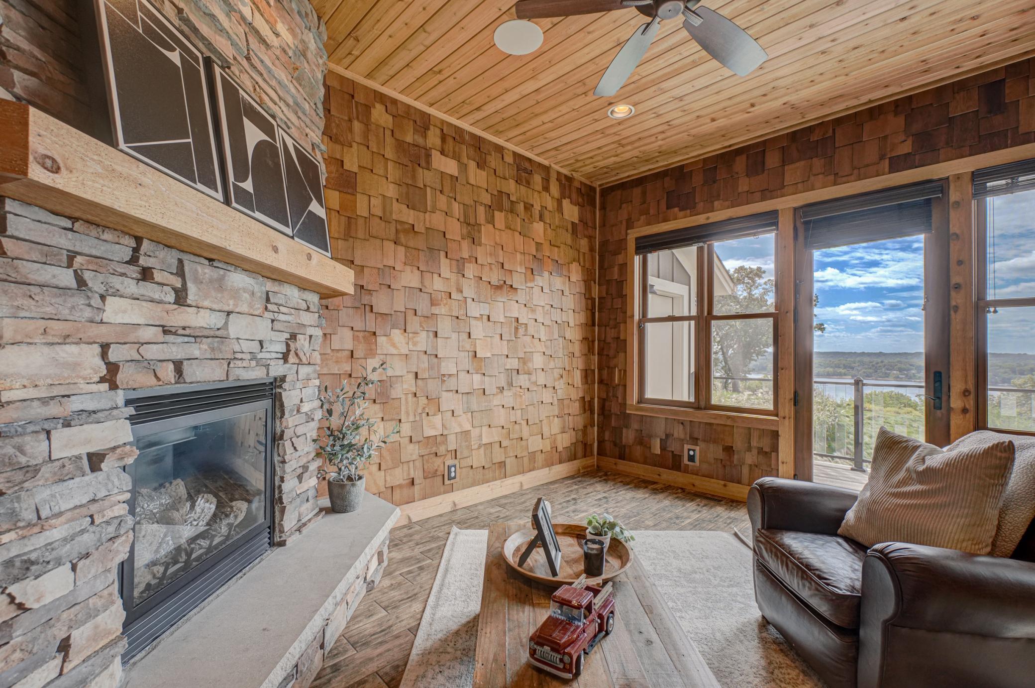 Off the kitchen, a four-season porch with its own stone fireplace offers a cozy retreat with year-round views.