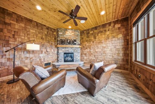 Off the kitchen, a four-season porch with its own stone fireplace offers a cozy retreat.