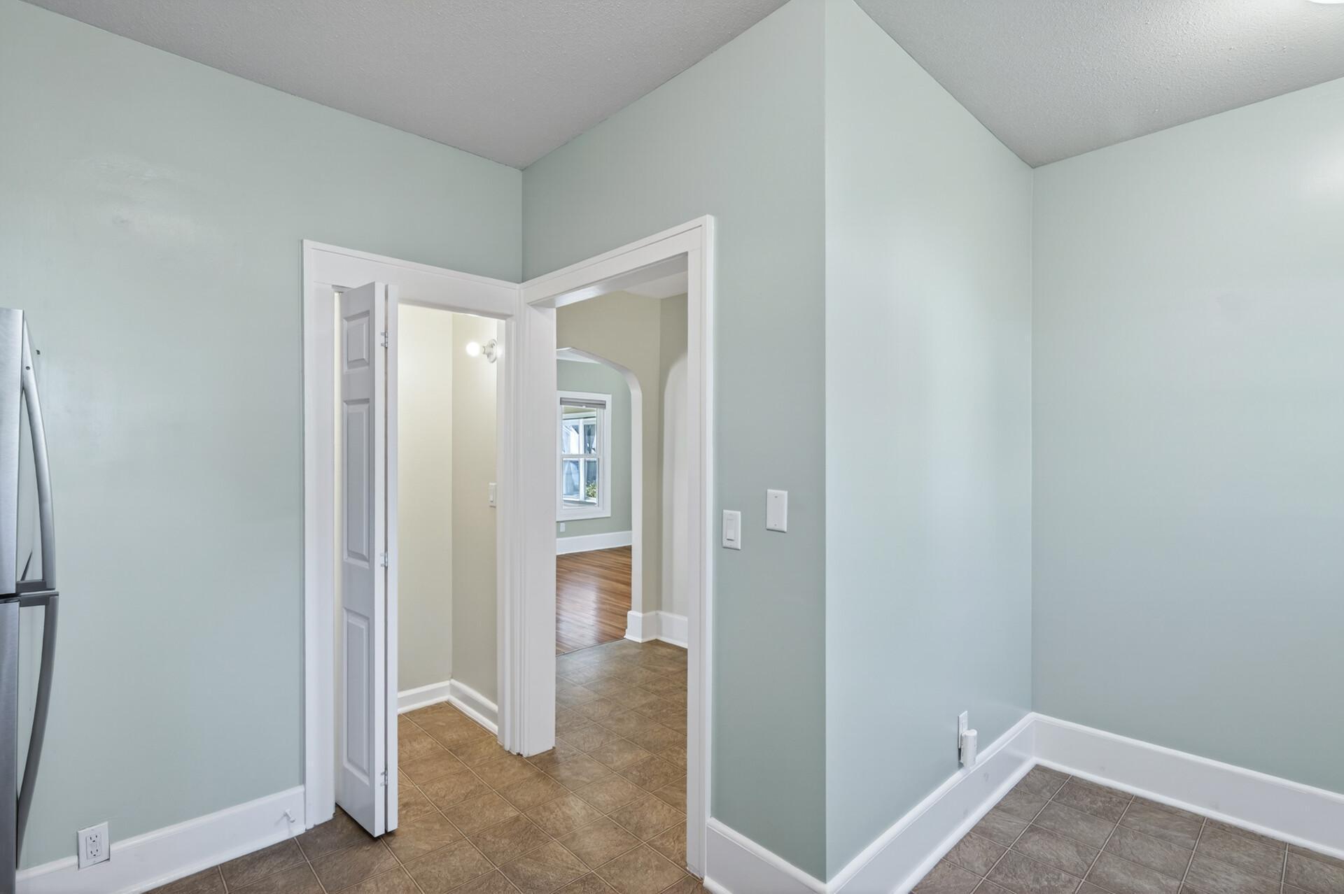Kitchen with view of hallway and side dining room