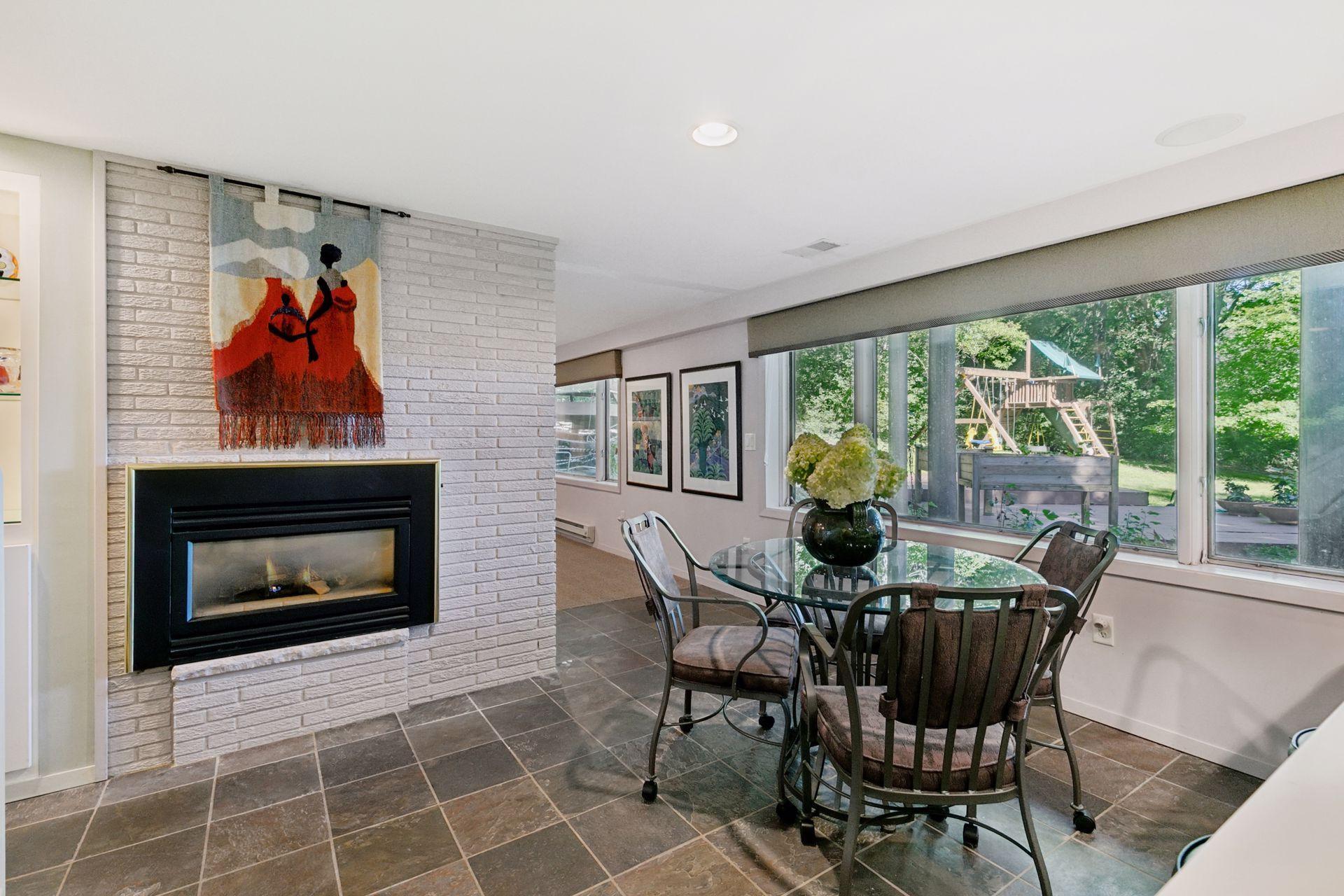 In addition to island with bar stools, there is room for a table seating four. Note the beautiful slate flooring.