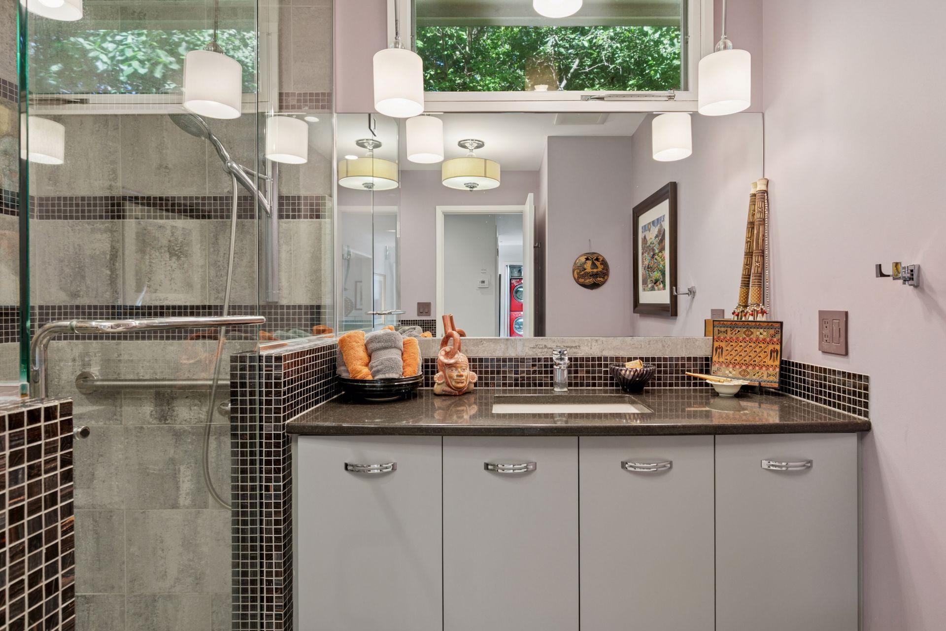 Main floor bath features shower and jetted tub with gorgeous tile!