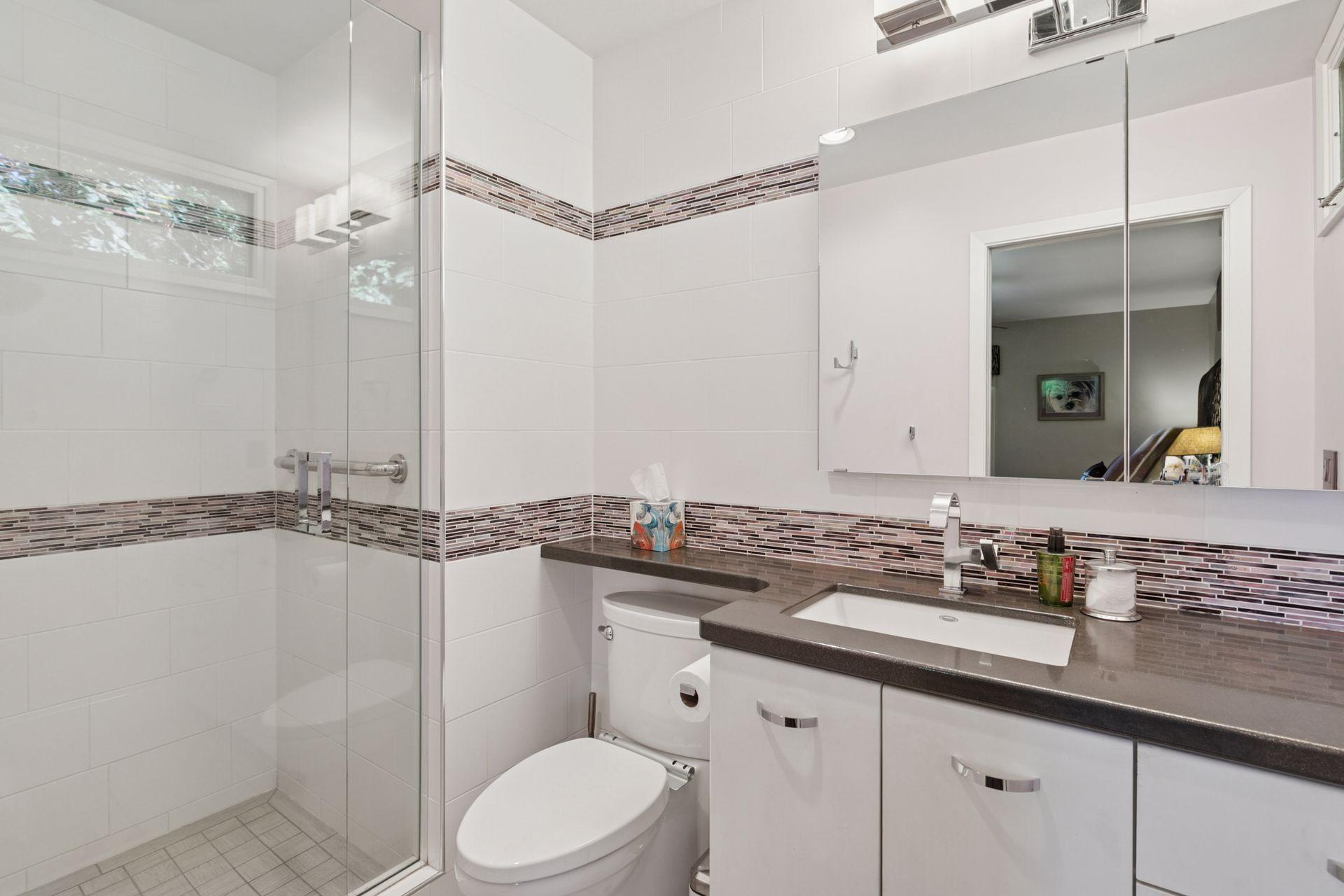 En suite master bath features elegant tile.