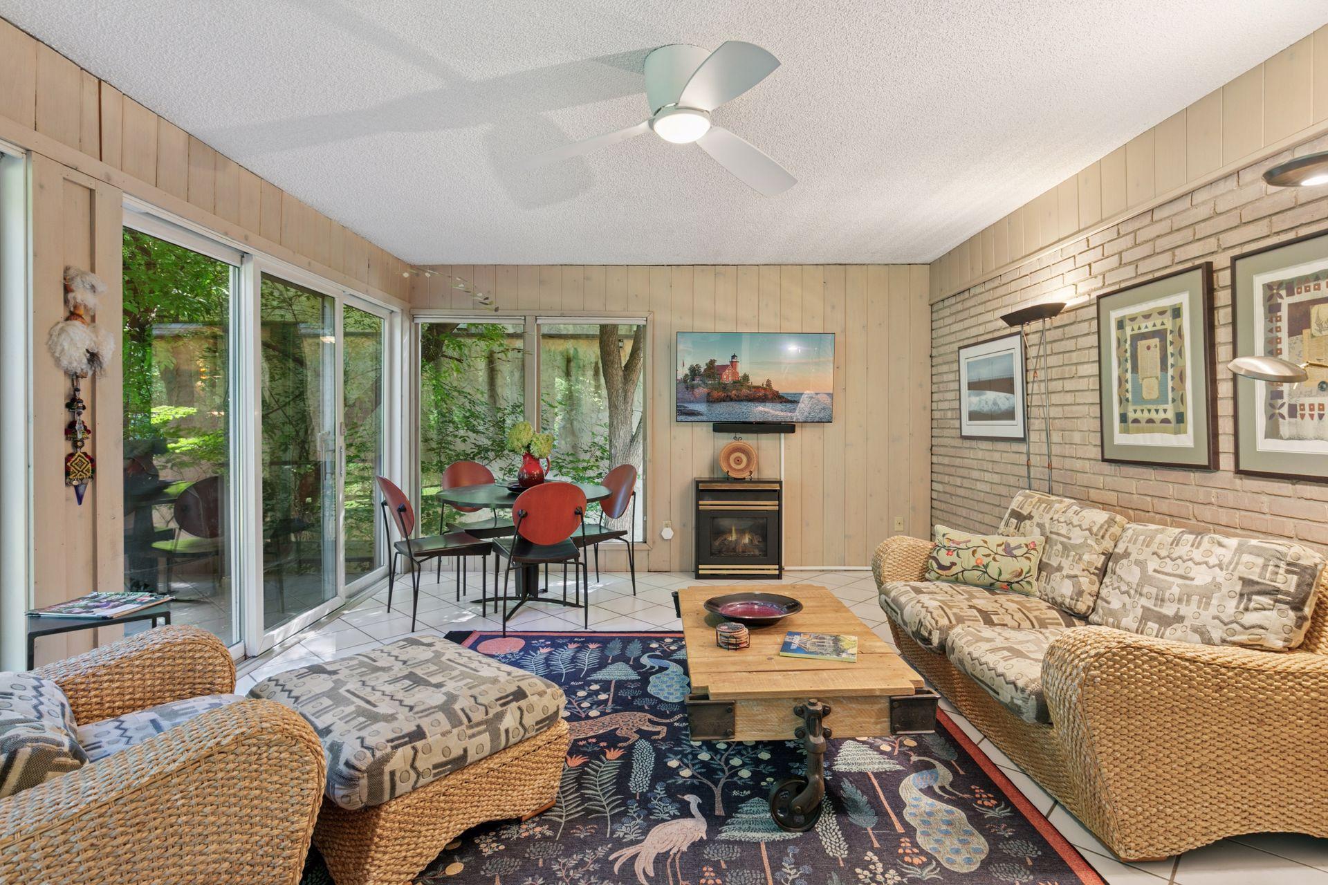 Four season porch also has lake views! Gas fireplace is perfect for cozy fall or winter evenings.