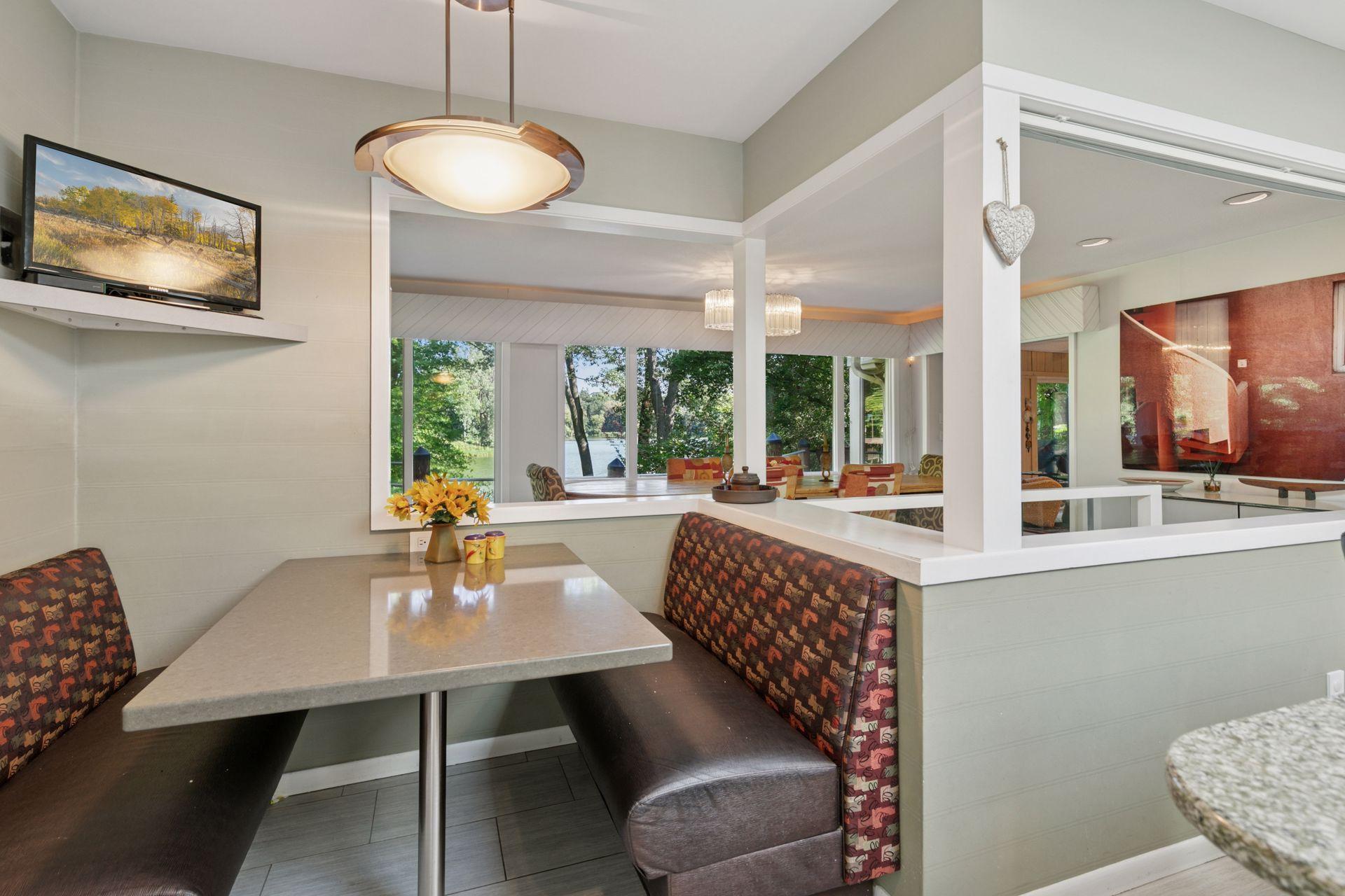 Kitchen opens to dining room and features a cozy breakfast nook.
