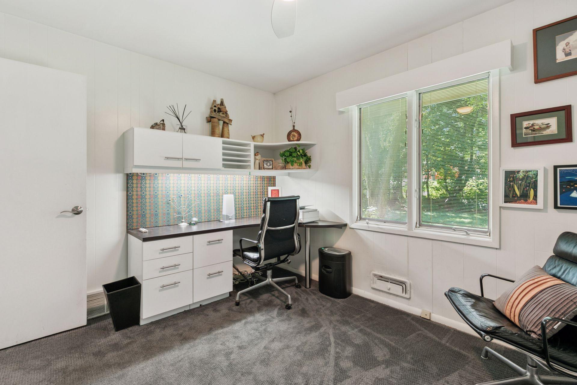 Third main floor bedroom, currently used as an office, converts to bedroom with built-in Murphy bed opposite desk.